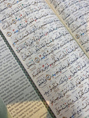 Maqdis Al-Quran Al Kareem A4 size with black cover, featuring word-by-word English and Arabic translation and color-coded Tajweed rules